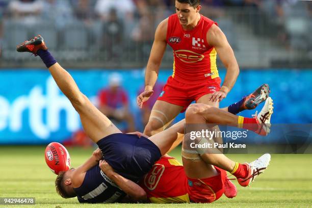 Tommy Sheridan of the Dockers gets tackled during the round three AFL match between the Gold Coast Suns and the Fremantle Dockers at Optus Stadium on...