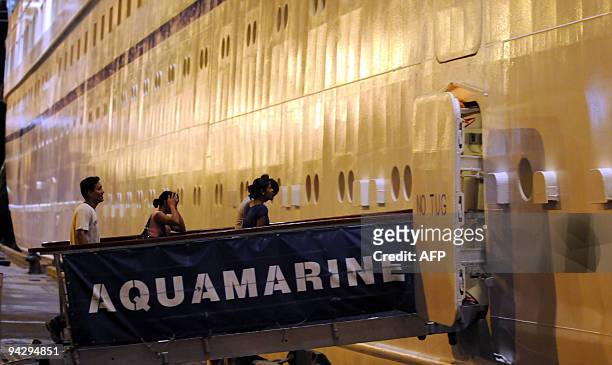 This picture taken on December 7 shows passengers boarding the cruise liner 'Aquamarine' while at berth at Sri Lanka's main port in Colombo....