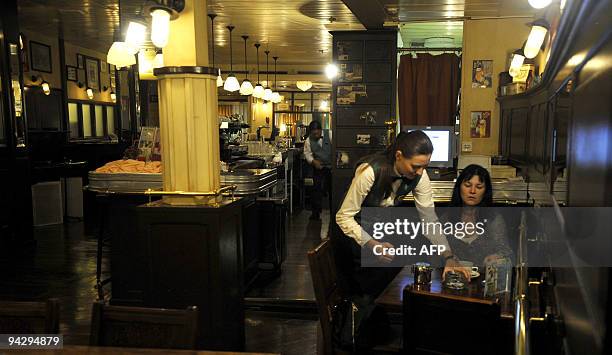 This picture taken on December 7 shows a passenger being served by a member of staff the cruise liner 'Aquamarine' while at berth at Sri Lanka's main...