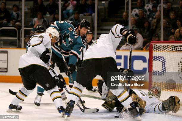 Joe Thornton of the San Jose Sharks has a shot on goal stopped Marty Turco of the Dallas Stars at HP Pavilion on December 11, 2009 in San Jose,...