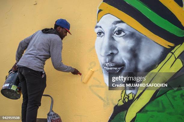 Graffiti artist paints a portrait of the late South African anti-apartheid campaigner, Winnie Madikizela-Mandela, ex-wife of former South African...