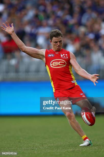 Nick Holman of the Suns passes the ball during the round three AFL match between the Gold Coast Suns and the Fremantle Dockers at Optus Stadium on...