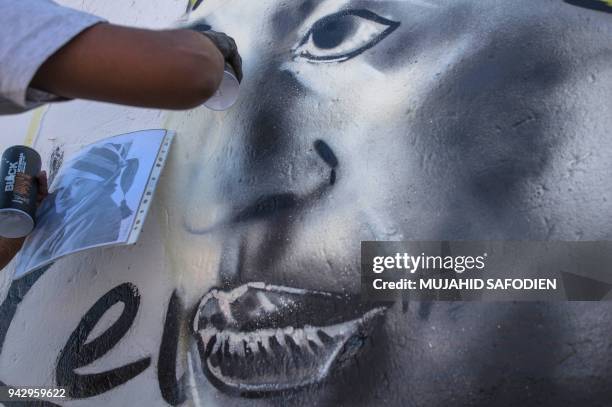 Graffiti artist paints a portrait of the late South African anti-apartheid campaigner, Winnie Madikizela-Mandela, ex-wife of former South African...