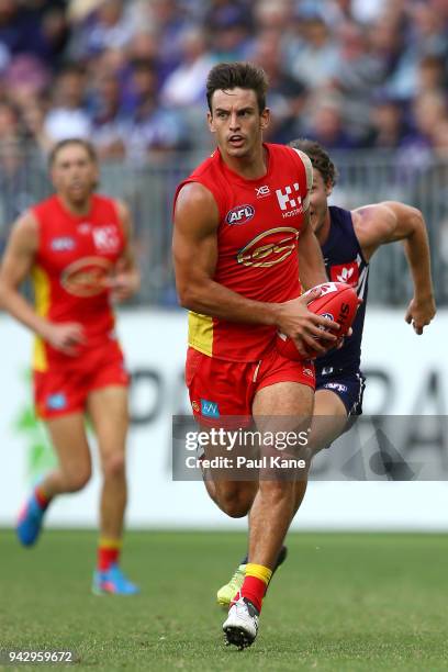 Jarryd Lyons of the Suns looks to pass the ball during the round three AFL match between the Gold Coast Suns and the Fremantle Dockers at Optus...