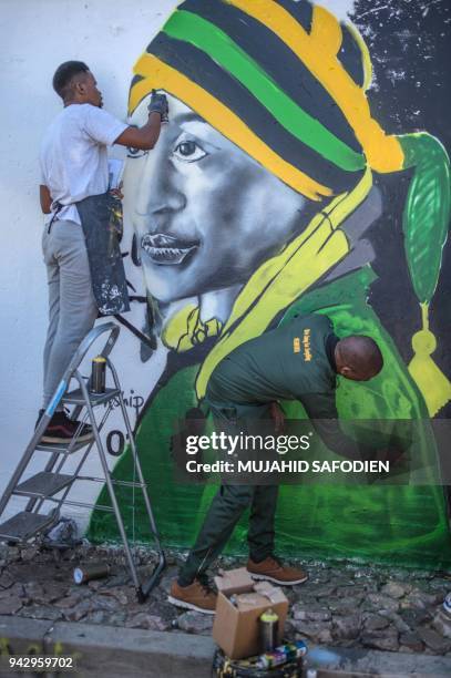 Graffiti artists paint a portrait of the late South African anti-apartheid campaigner, Winnie Madikizela-Mandela, ex-wife of former South African...