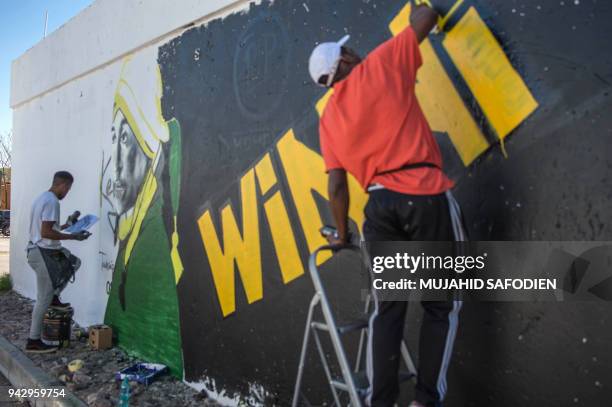 Graffiti artists paint a portrait of the late South African anti-apartheid campaigner, Winnie Madikizela-Mandela, ex-wife of former South African...