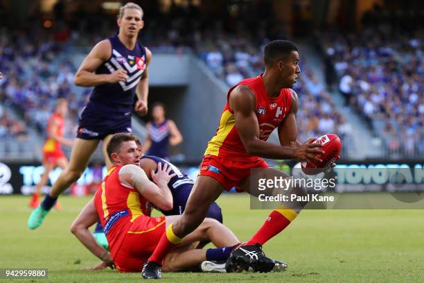 Touk Miller of the Suns looks to pass the ball during the round three AFL match between the Gold Coast Suns and the Fremantle Dockers at Optus...