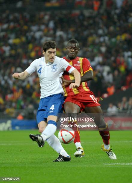 Gareth Barry of England and Sulley Muntari of Ghana in action during the international friendly match between England and Ghana at Wembley Stadium on...