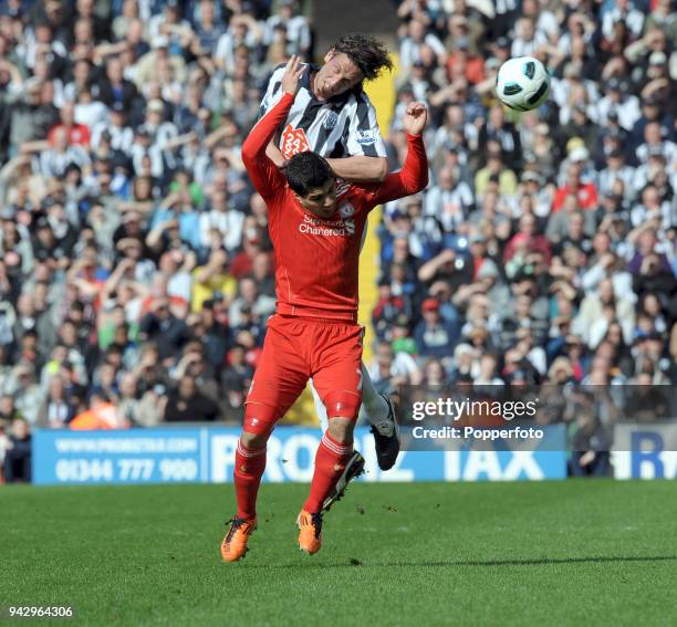 Luis Suarez of Liverpool and Jonas Olsson of West Bromwich Albion in action during the Barclays Premier League match between West Bromwich Albion and...