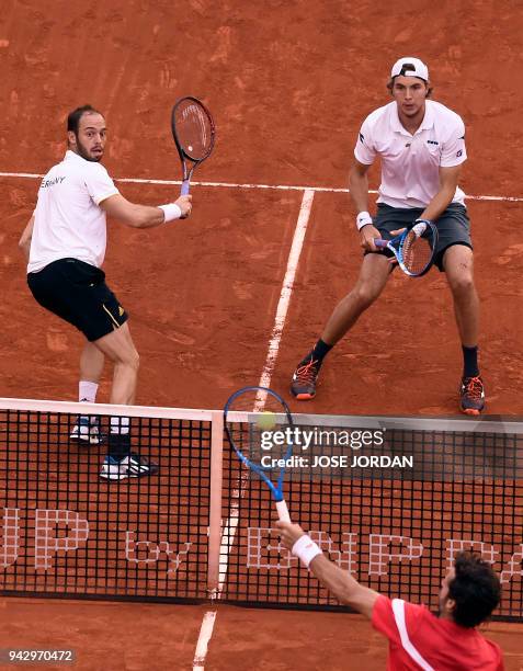 Spain's Feliciano Lopez returns the ball during the Davis Cup quarter-final doubles tennis match against Germany's Tim Puetz and Germany's...