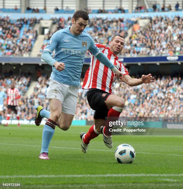 Adam Johnson of Manchester City and Phil Bardsley of Sunderland in action during the Barclays Premier League match between Manchester City and...