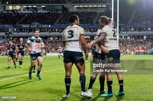 Kyle Feldt of the Cowboys os congratulated by team mates after scoring a try during the round five NRL match between the New Zealand Warriors and the...