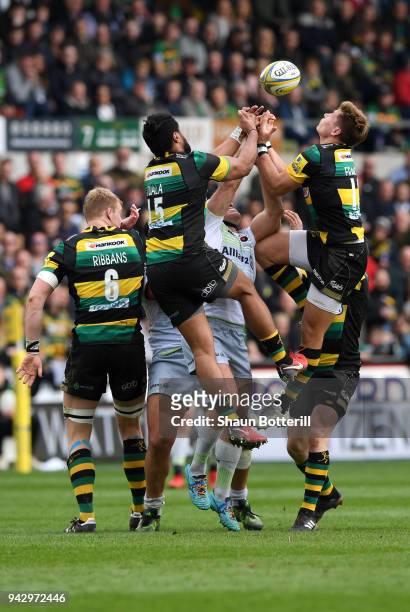 Ashee Tuala and George North of Northampton Saints jump for the ball during the Aviva Premiership match between Northampton Saints and Saracens at...