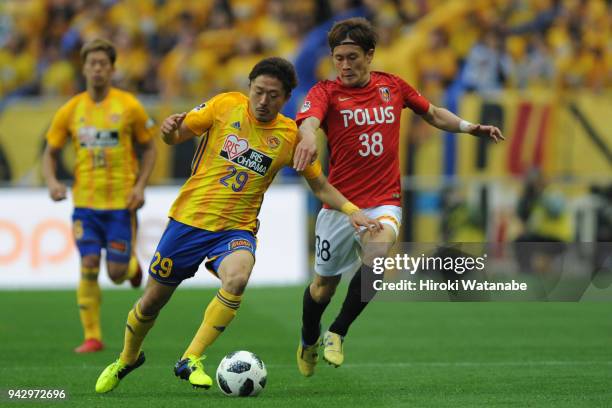 Shota Kobayashi of Vegalta Sendai and Daisuke Kikuchi compete for the ball during the J.League J1 match between Urawa Red Diamonds and Vegalta Sendai...