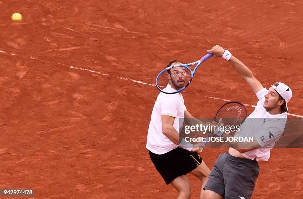 Germany's Jan-Lennard Struff and Germany's Tim Puetz return the ball during the Davis Cup quarter-final doubles tennis match against Spain's Marc...