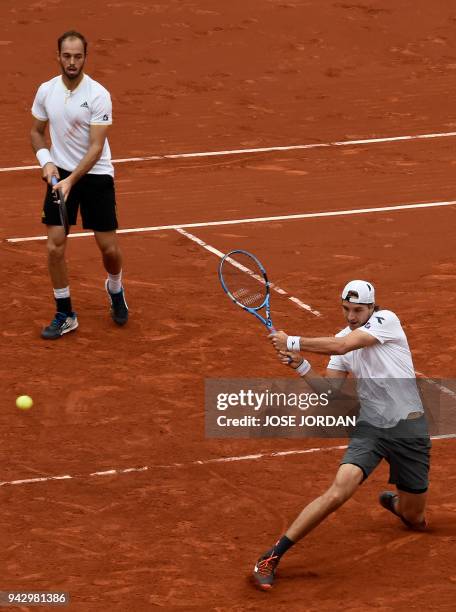 Germany's Tim Puetz and Germany's Jan-Lennard Struff return the ball during the Davis Cup quarter-final doubles tennis match against Spain's Marc...