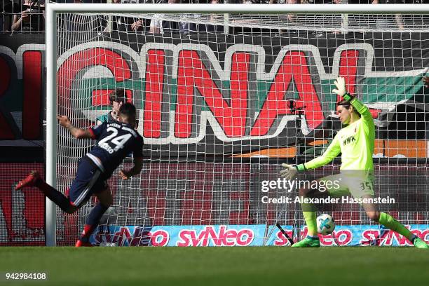 Tolisso of Bayern Muenchen scores a goal to make it 1:1 past goalkeeper Marwin Hitz of Augsburg, during the Bundesliga match between FC Augsburg and...