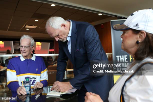 Former Utah Jazz player Mark Eaton autographs his book before the game against the Los Angeles Lakers on April 3, 2018 at vivint.SmartHome Arena in...