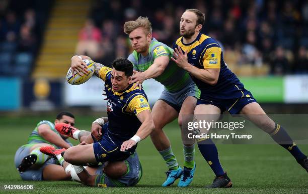 Bryce Heem of Worcester Warriors is tackled by Nili Latu of Newcastle Falcons and Charlie Harris of Newcastle Falcons during the Aviva Premiership...