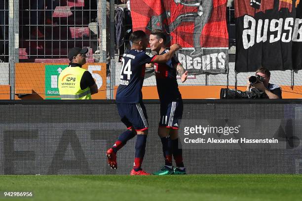 James Rodriguez of Bayern Muenchen celebrates with Tolisso of Bayern Muenchen after he scored a goal to m are it 1:2 during the Bundesliga match...