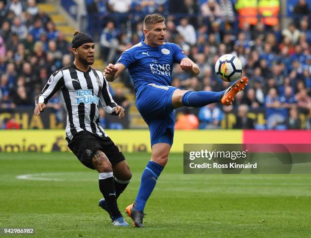 Marc Albrighton of Leicester City is challenged by Deandre Yedlin of Newcastle United during the Premier League match between Leicester City and...