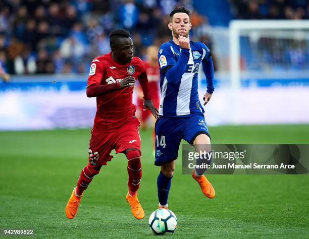 Amath Ndiaye of Getafe CF duels for the ball with Jorge Franco 'Burgui' of Deportivo Alaves during the La Liga match between Deportivo Alaves and...