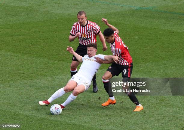 Lee Cattermole and Ashley Fletcher of Sunderland try to stop Kalvin Philips of Leeds during the Sky Bet Championship match between Leeds United and...