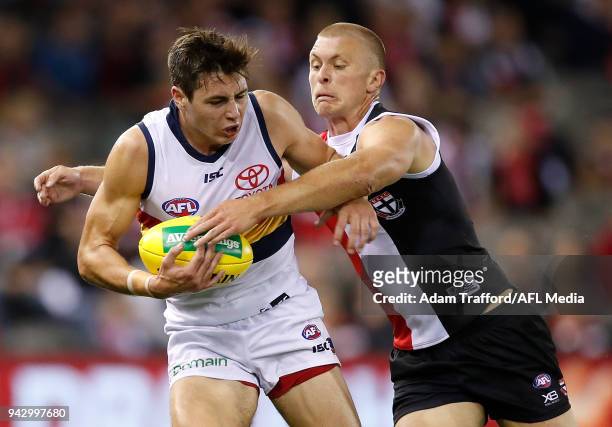 Jake Kelly of the Crows is tackled by Sebastian Ross of the Saints during the 2018 AFL round 03 match between the St Kilda Saints and the Adelaide...