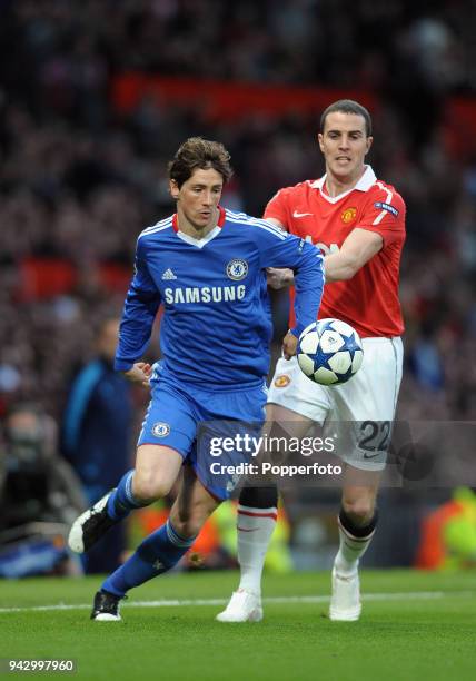 Fernando Torres of Chelsea and John O'Shea of Manchester United in action during the UEFA Champions League Quarter-Final second leg match between...