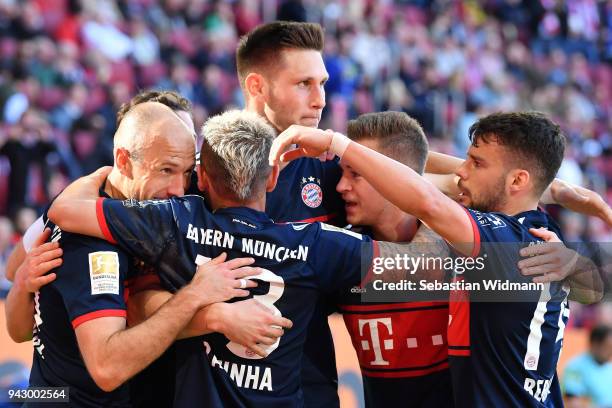 Arjen Robben of Bayern Muenchen celebrates scoring his teams third goal with his teammates during the Bundesliga match between FC Augsburg and FC...