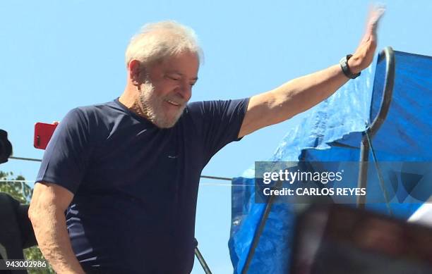 This screen grab shows Brazilian ex-president Luiz Inacio Lula da Silva waving to supporters at the metalworkers' union building in Sao Bernardo do...
