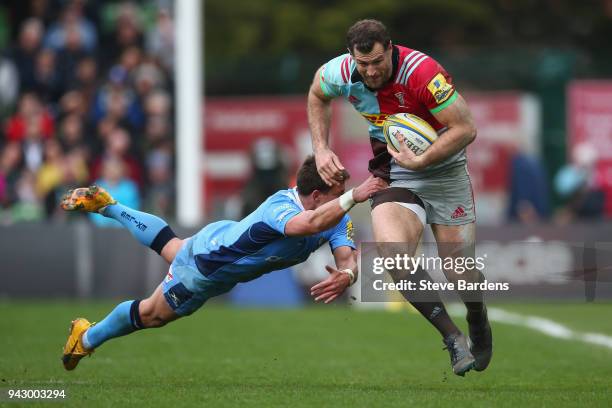 Tim Visser of Harlequins breaks the tackle of Piet van Zyl of London Irish during the Aviva Premiership match between Harlequins and London Irish at...