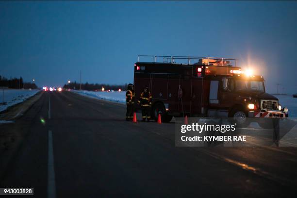 An emergency vehicle is seen near the crash site on April 6, 2018 after a bus carrying a junior ice hockey team collided with a semi-trailer truck...