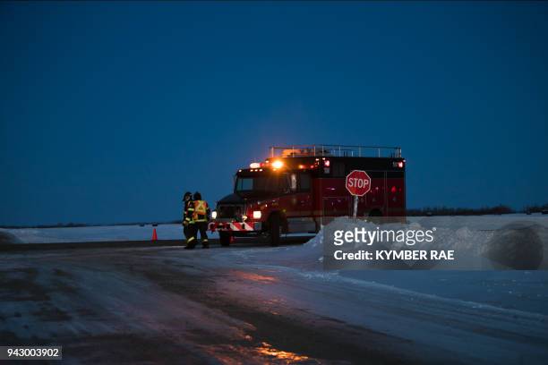 An emergency vehicle is seen near the crash site on April 6, 2018 after a bus carrying a junior ice hockey team collided with a semi-trailer truck...