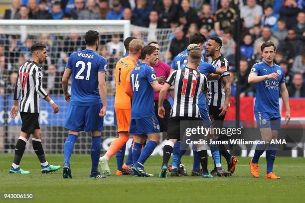 Harry Maguire of Leicester City clashes with Jamaal Lascelles of Newcastle United during the Premier League match between Leicester City and...