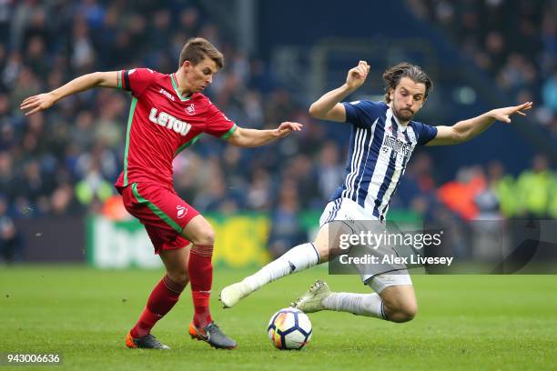 Jay Rodriguez of West Bromwich Albion and Tom Carroll of Swansea City battle for the ball during the Premier League match between West Bromwich...