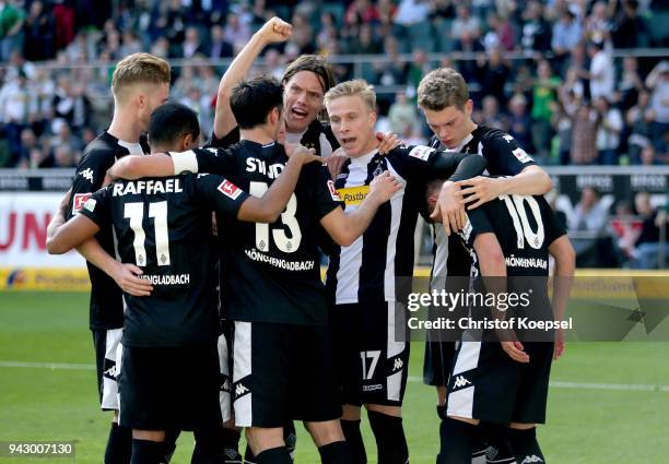 Thorgan Hazard of Moenchengladbach celebrates his second goal with his team mates during the Bundesliga match between Borussia Moenchengladbach and...