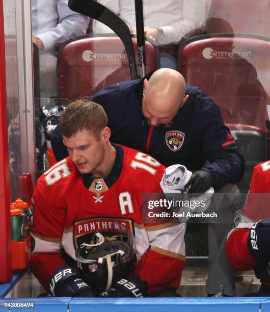 Aleksander Barkov of the Florida Panthers is checked by a staff member after being injured during third period action against the Boston Bruins at...