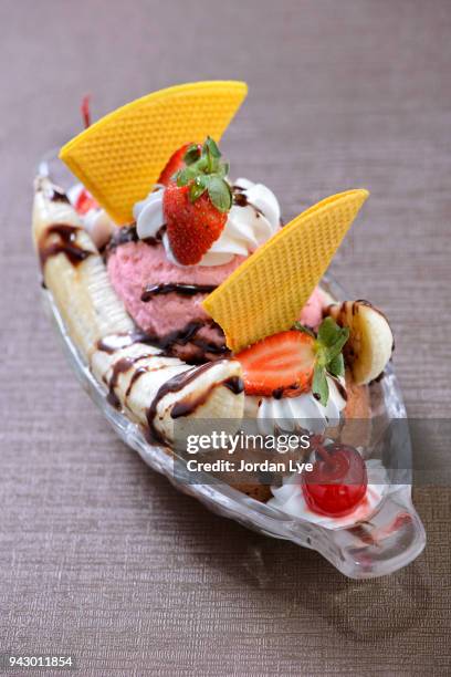 banana split, and ice cream dessert with toppings - strawberry syrup stock pictures, royalty-free photos & images