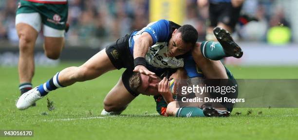George Ford of Leicester holds onto the ball as Kahn Fotuali'i challenges during the Aviva Premiership match between Bath Rugby and Leicester Tigers...
