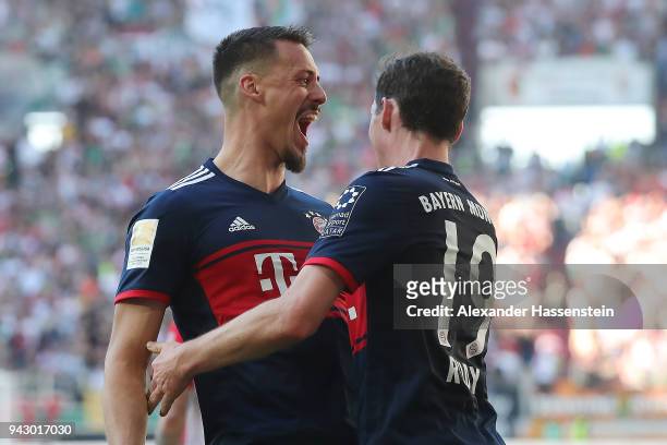 Sandro Wagner of Muenchen celebrates with Sebastian Rudy of Bayern Muenchen after he scored a goal to make it 1:4 during the Bundesliga match between...