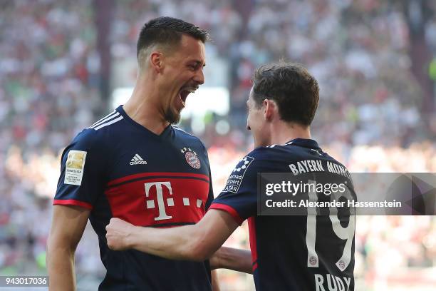 Sandro Wagner of Muenchen celebrates with Sebastian Rudy of Bayern Muenchen after he scored a goal to make it 1:4 during the Bundesliga match between...