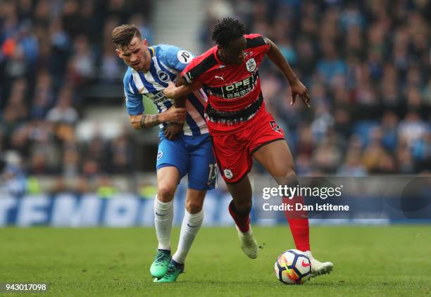 Terence Kongolo of Huddersfield Town is challenged by Pascal Gross of Brighton and Hove Albion during the Premier League match between Brighton and...