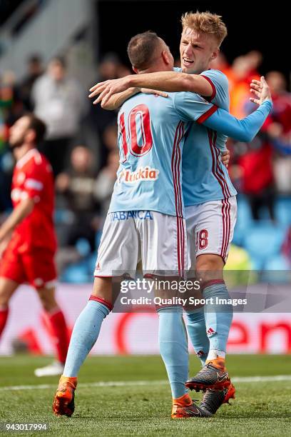 Iago Aspas and Daniel Wass of Celta de Vigo celebrate Guilherme Arana of Sevilla FC scores by own goal during the La Liga match between Celta de Vigo...