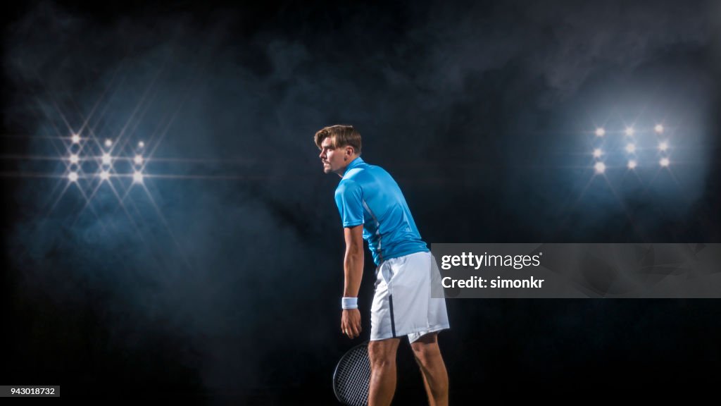 Male tennis player serving