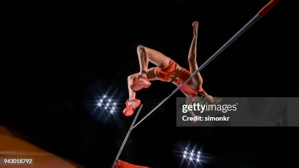 high jumper jumping over bar - mens high jump stock pictures, royalty-free photos & images