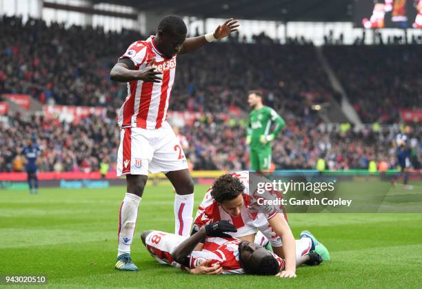 Mame Biram Diouf of Stoke City goes down injured after scoring his sides first goal during the Premier League match between Stoke City and Tottenham...