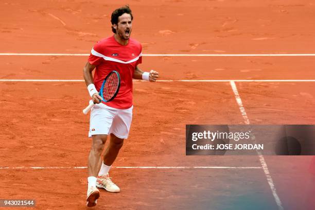 Spain's Feliciano Lopez celebrates after winning a set against Germany's Tim Puetz and Germany's Jan-Lennard Struff during the Davis Cup...