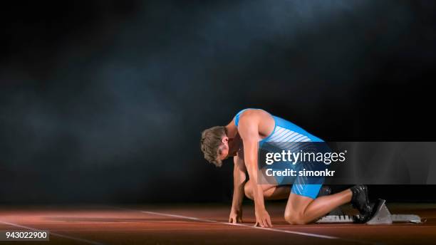 male sprinter at starting blocks - design sprint stock pictures, royalty-free photos & images