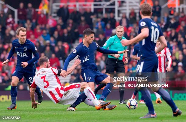 Stoke City's Dutch defender Erik Pieters fouls Tottenham Hotspur's Argentinian midfielder Erik Lamela during the English Premier League football...